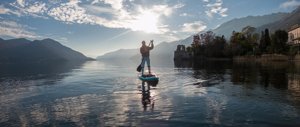 First person point of view of a woman paddling on a stand up paddle board